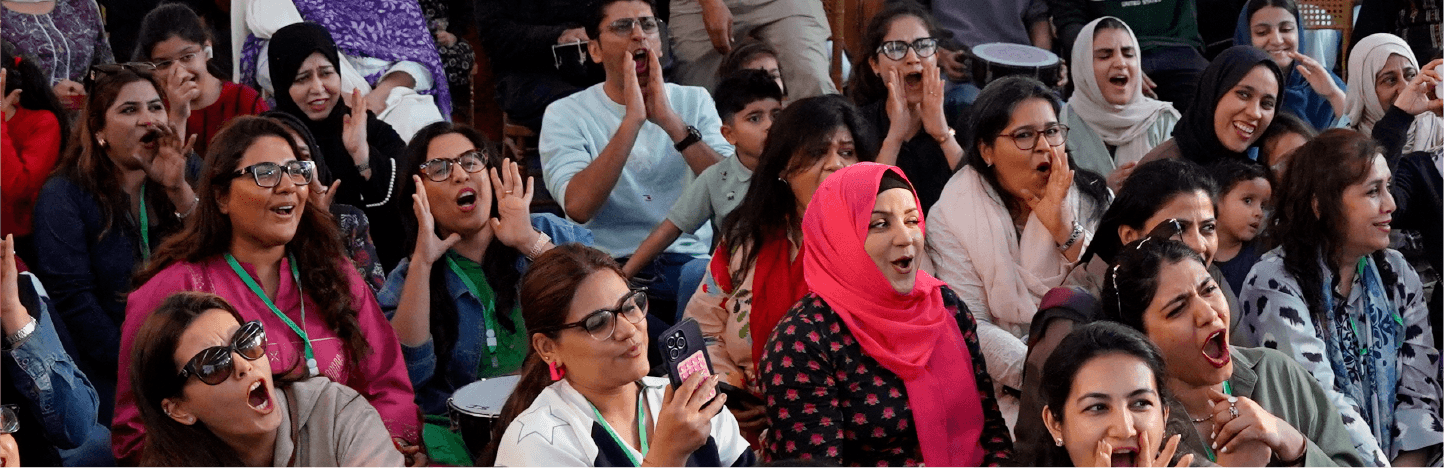 Animated, expressive crowd enjoying stage performances.